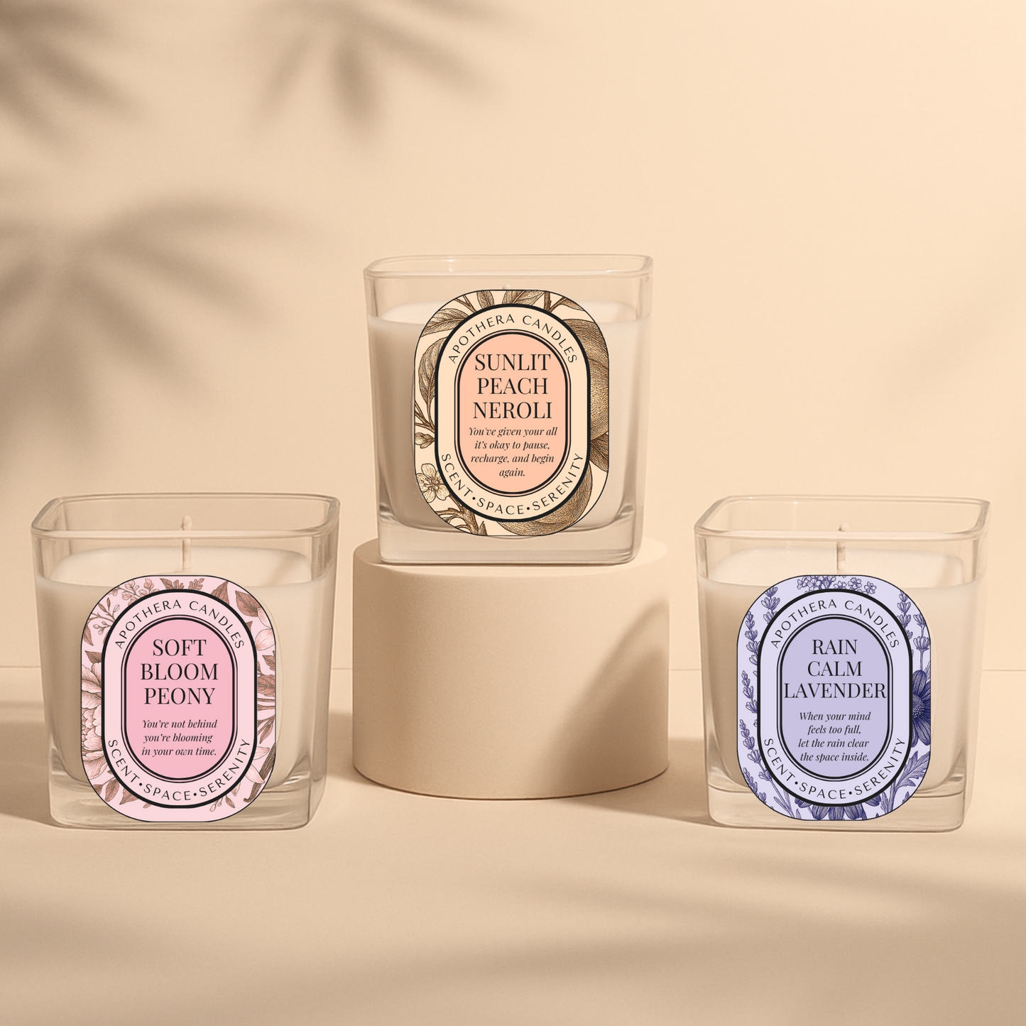 ApoThera’s Rebalance Ritual Collection featuring three signature candles—Soft Bloom Peony, Sunlit Peach Neroli, and Rain Calm Lavender—presented in a minimal, serene display.